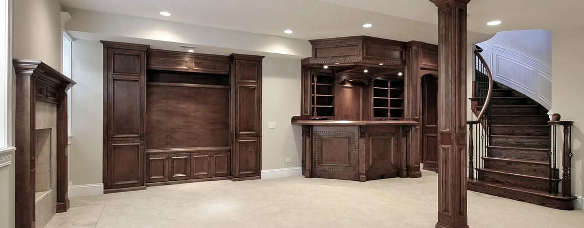Finished basement renovation with custom millwork and a wet bar by Walter Construction