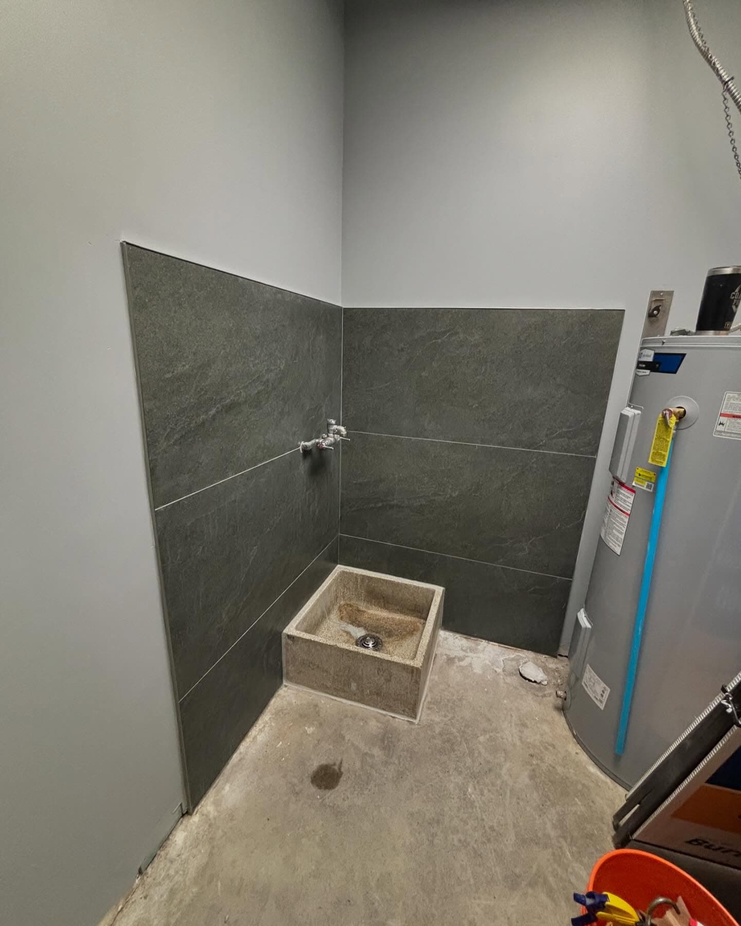 Tiled dog-wash and utility room with slate-look tile