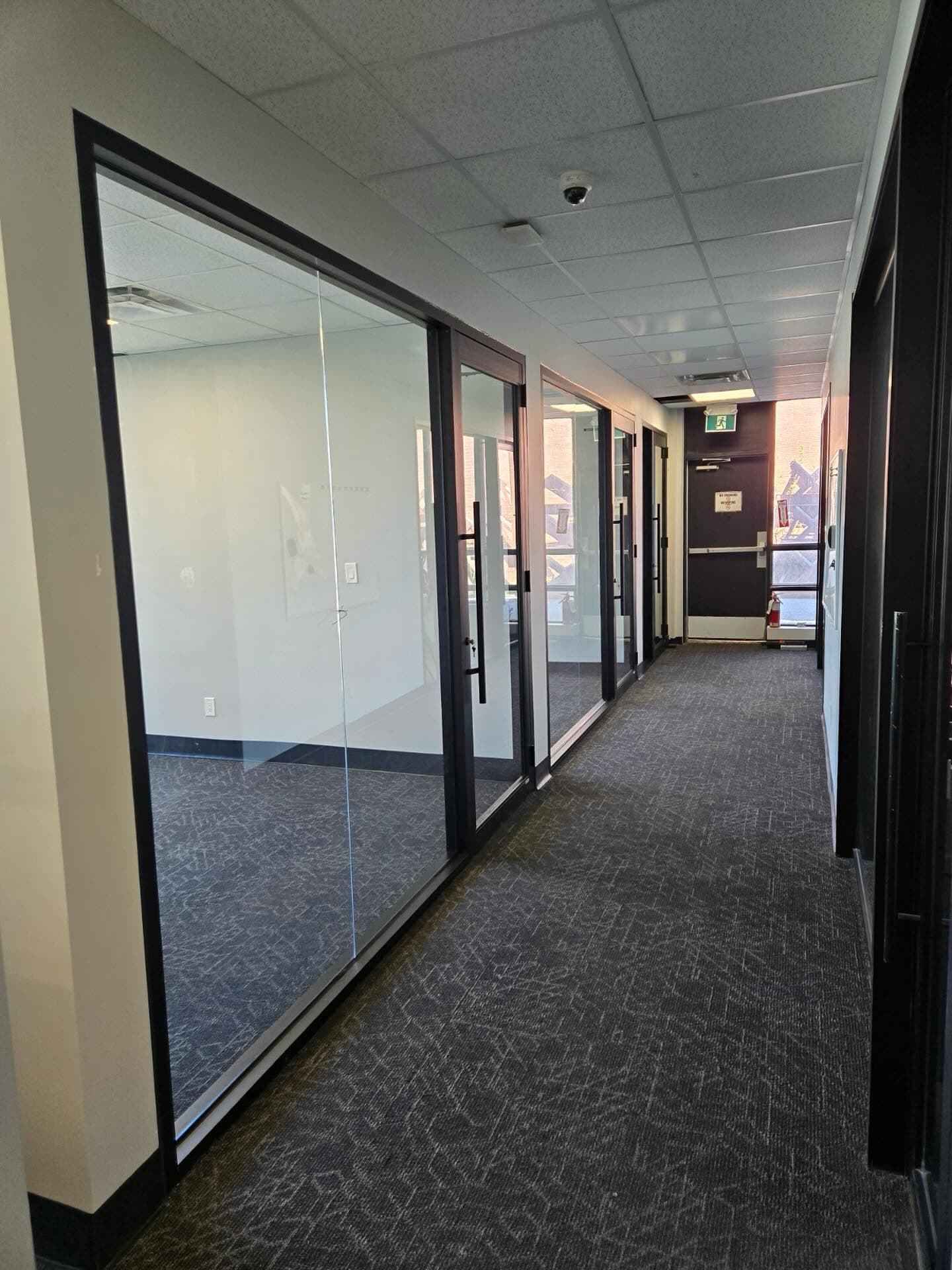 Completed commercial office fit-out with glass-walled offices